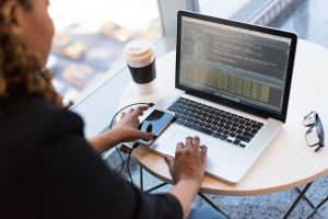 Employees working on company laptops in an office. If the single-post theme template already prints the post title, delete the eyebrow + h1 below so the page does not carry two H1s.