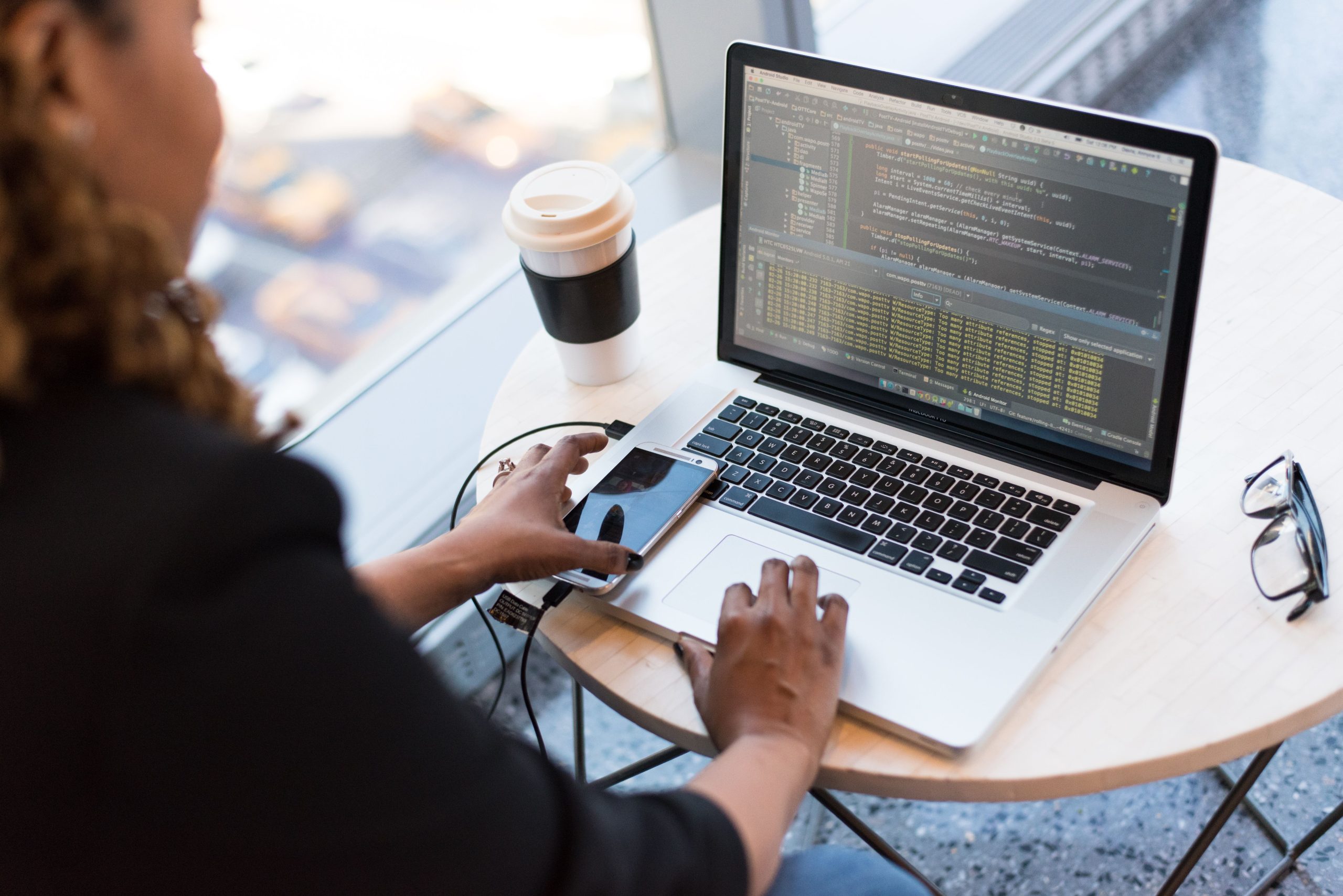 Employees working on company laptops in an office. If the single-post theme template already prints the post title, delete the eyebrow + h1 below so the page does not carry two H1s.
