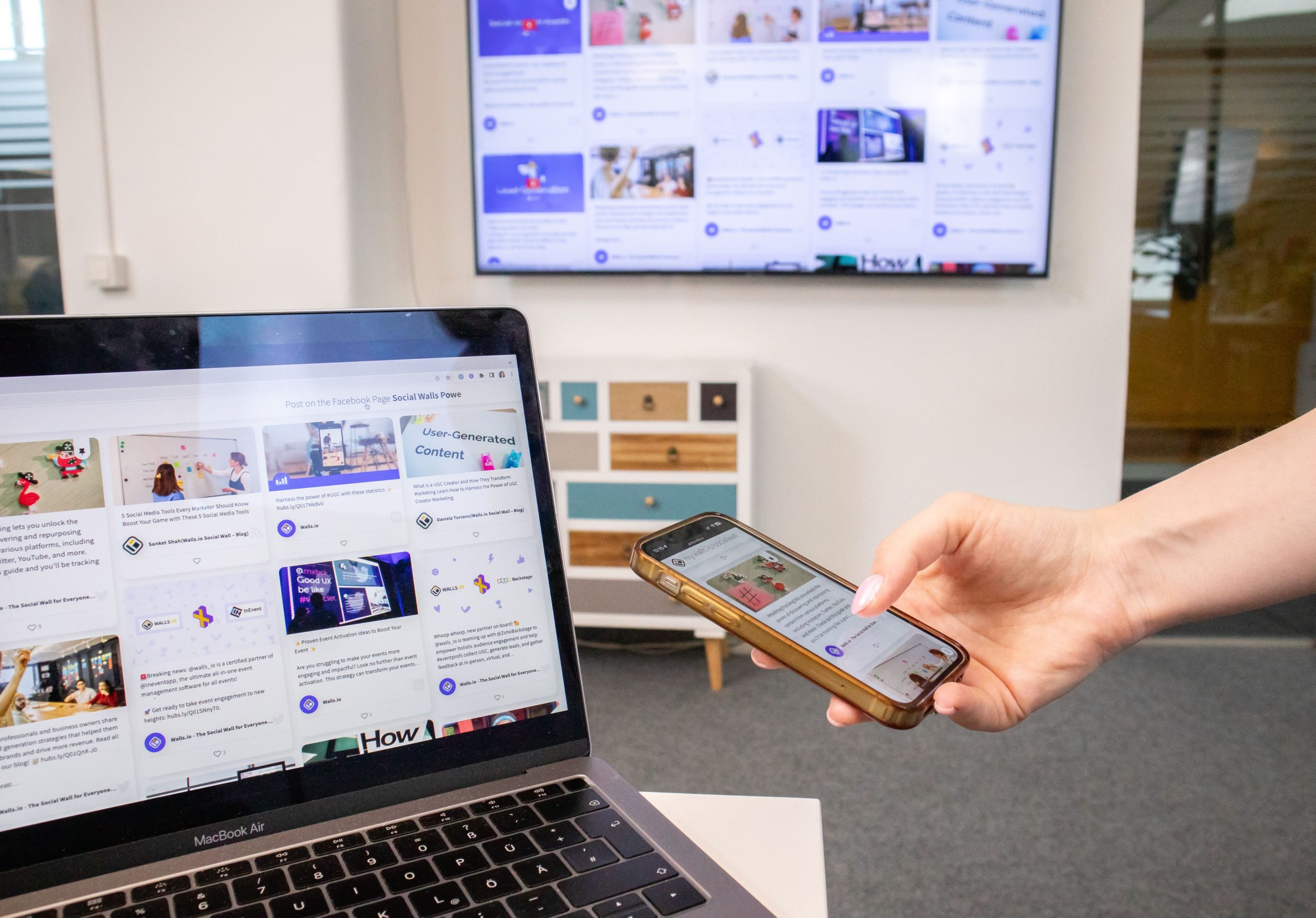 A smartphone and laptop being used in an office.