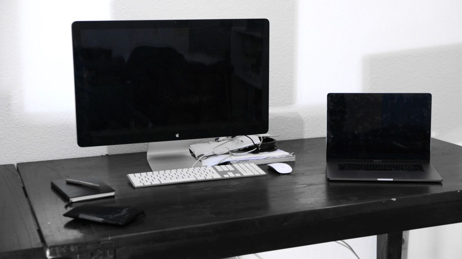 Desktop computer and laptop in a business workspace.